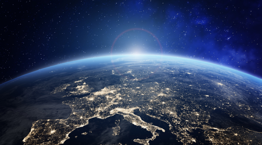 Planet Earth viewed from space with city lights in Europe. World with sunrise. Conceptual image for global business or European communication technology, elements from NASA